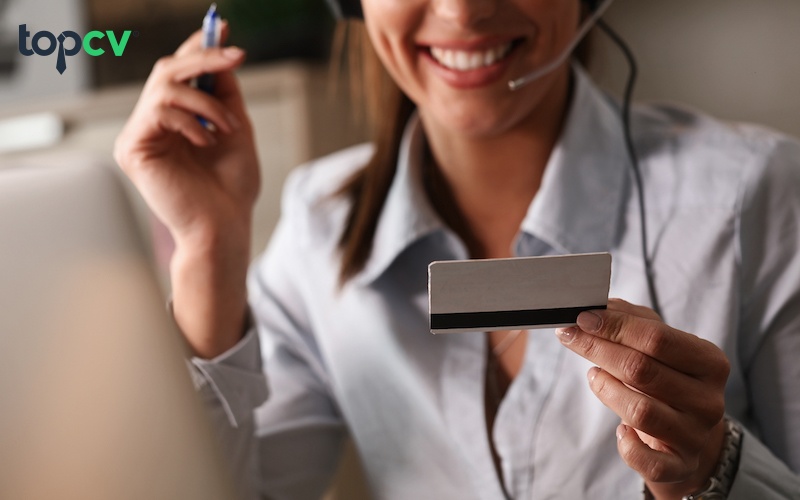 Close up of happy woman using credit card for online banking.